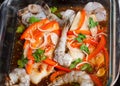 Raw tilapia fillets baked with shrimps and vegetables
