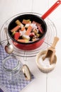 Preparation of home made rhubarb jam in a red enamel pot Royalty Free Stock Photo