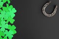 Preparation of horseshoes and clovers for the feast of St. Patrick. Good luck symbols on dark background for design top