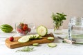 Preparation of Infused water with strawberry and meloncella that is hybrid of cucumber and melon, thyme, mint. Royalty Free Stock Photo