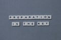 ' Preparation Is The Key ' word made of square letter word on grey background Royalty Free Stock Photo