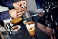 Preparation of latte macchiato with cinnamon Royalty Free Stock Photo