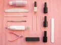 Preparation for manicure or pedicure with gel nail polish set on pink background, top view.