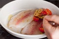 Preparation of mediterranean style baked fish with vegetables