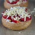 Preparation of mini pizza with cheese ready for baking