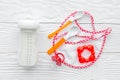 Preparation of mixture baby feeding with infant formula powdered milk in bottle with bib on white background top view Royalty Free Stock Photo