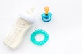 Preparation of mixture baby feeding with infant formula powdered milk in bottle with toys on white background top view Royalty Free Stock Photo