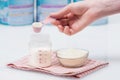 Preparation of mixture baby feeding on white table background Royalty Free Stock Photo