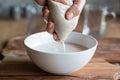 Preparation of nut milk - straining the milk through a milk bag Royalty Free Stock Photo