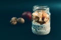 Preparation overnight breakfast with flakes of oats, chia, apple