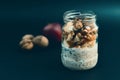 Preparation overnight breakfast with flakes of oats, chia, apple