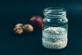 Preparation overnight breakfast with flakes of oats, chia, apple