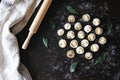 Preparation of pelmeni. Top view. Ingredients on black table. Traditional Russian cuisine.