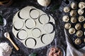 Preparation of pelmeni. Top view. Ingredients on black table. Traditional Russian cuisine.