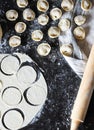 Preparation of pelmeni. Top view. Ingredients on black table. Traditional Russian cuisine.