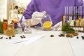 Preparation of perfumes from natural ingredients, aromatherapy. Fresh flowers and natural ingredients in chemical test