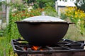 Preparation pilaf in the cauldron on fire