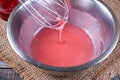 Preparation of pink icing in a bowl Royalty Free Stock Photo
