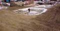 Preparation for pouring concrete, the foundation of the house. A worker works with a shovel on a construction site