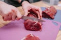 Preparation of raw meat roll. Cooking steaks and meat rolls in the cooking class. Sliced meat on a plate Royalty Free Stock Photo