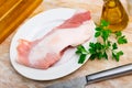 Preparation of raw pork cinch parsley and garlic on wooden board