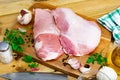 Preparation of raw pork cinch parsley and garlic on wooden board