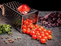 Preparation recipe tomato juice. Large tomato and old grater down to small grape cherry tomatoes on retro vintage rustic gray ston Royalty Free Stock Photo