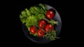 Preparation of salad on a gray plate and on a black background