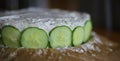 Preparation of Smorgastarta, a typical Swedish dish, with cucumber slices