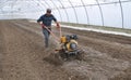 Preparation of soil in the greenhouse for planting vegetable crops using a mini tractor