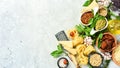 Preparation of spaghetti: pesto sauce, pasta, basil, parmesan and nuts, olive oil. On a concrete background. Royalty Free Stock Photo