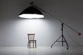 Preparation for studio shooting: empty chair and studio lighting Royalty Free Stock Photo