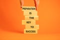 Preparation and success symbol. Wooden blocks with words Preparation is the key to success on on a beautiful orange background, Royalty Free Stock Photo