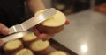 Preparation of tarts with mousse. A mini-tart in the hands of a pastry chef Royalty Free Stock Photo