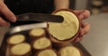 Preparation of tarts with mousse. A mini-tart in the hands of a pastry chef Royalty Free Stock Photo