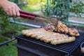 Preparation of tasty sausages and meat on the gil.