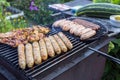 Preparation of tasty sausages and meat on the gil.