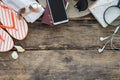 Preparation for travel,smartphone and passport with glasses and flip flops on old wooden table