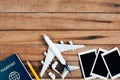 Preparation for Traveling concept, airplane, Photo frame, earphone, pencil, passport. Royalty Free Stock Photo