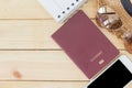 Preparation for Traveling concept, passport, smartphone, sunglasses, noted book, hat on a wooden background