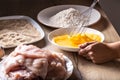 Preparation of wiener schnitzels as hand of a person whisks eggs in a plate