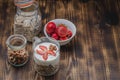 preparation of yogurt with a granule, nuts and strawberry on a wooden table. Copyspace Royalty Free Stock Photo