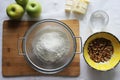 Preparations for Apple pie: flour, apples, butter, nuts. Homemade cake Royalty Free Stock Photo