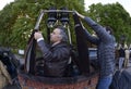 Preparations for ballooning: men standing in a basket and checking anchorages of a gas burners Royalty Free Stock Photo