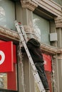 Preparations for Christmas have begun in the city. Workers install a light garland on the facade of the building