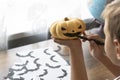 Preparations for halloween. close up image of boy dawing scarring face on orange pumpkin. Royalty Free Stock Photo