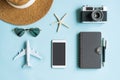 Flat lay of accessories and travel items on blue desk. Summer, holiday and planning a trip concepts. Top view, copy Royalty Free Stock Photo