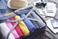 Prepare accessories for new journey and travel to long weekend trip, packing clothes in suitcase bag on bed Royalty Free Stock Photo