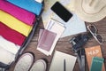 Prepare accessories and travel items, for new journey, packing clothes in suitcase bag on wooden board, flat lay, top view Royalty Free Stock Photo