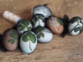 Easter eggs painted onion peel with a pattern of fresh herbs on a wooden ancient background. We color the eggs according to the Royalty Free Stock Photo